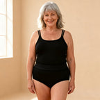 Woman in her sixties wearing the black high-waisted Dried Angels leak protection panty, front view